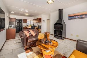 a living room with a couch and a fireplace at Namclassics in Langstrand