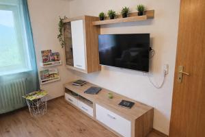 a living room with a flat screen tv on a wall at Ferienwohnung Panoramablick Bermersbach in Forbach +29 photos