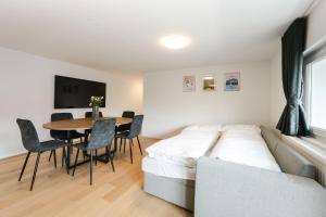 a bedroom with a bed and a table and chairs at LEVA Stay Luzern-Interlaken I Nature I Familie in Sarnen