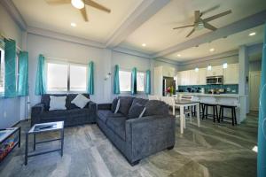 a living room with two couches and a kitchen at Villa Armoniosa Ocean View 2BR w/ Beachfront Pool - Upper Level in Placencia