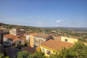 a group of buildings in a town with hills in the background at Relax House & Gym in Villanova Monteleone