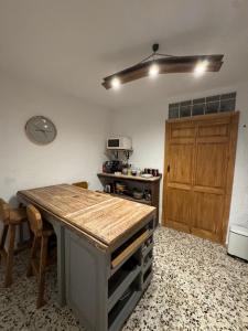 a kitchen with a wooden island in a room at Mil House in Cómpeta