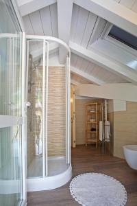 a bathroom with a shower and a glass door at Villa Giuliana - Attic apartment in Menaggio +44 photos