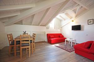 a living room with a red couch and a table at Villa Giuliana - Attic apartment in Menaggio