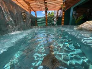 a large pool of water in a building at Casa Cayito Agua Dulce in Arecibo