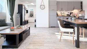 a kitchen and living room with a table and chairs at Dat Lütte Glück in Pruchten +4 photos