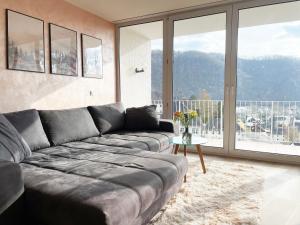 a living room with a couch and a large window at Schönes Apartment Traumblick mit Balkon Bad Ems in Bad Ems
