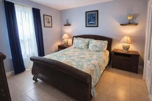 a bedroom with a bed with two night stands and two lamps at Swanky 2 Bedroom, Easy Walk to Beach Mar y Sol II # 1 in South Padre Island
