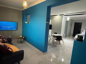 a living room with a blue wall and a table at Casa de Marcos in Swakopmund