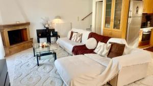 a living room with a couch and a table at SMART Apartments LOUTRAKI in Loutraki
