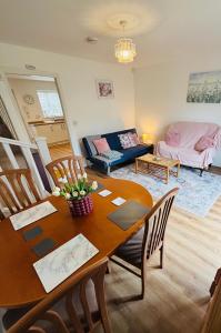 a living room with a table and a couch at Penuel 3-bedroom Retreat with workspace in Central Sutton-in-Ashfield in Sutton in Ashfield