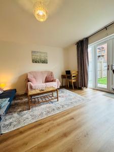 a living room with a couch and a table at Penuel 3-bedroom Retreat with workspace in Central Sutton-in-Ashfield in Sutton in Ashfield