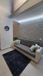a couch sitting in a living room with a rug at CASA CASCIOTTO in Palermo