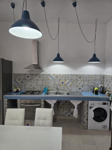 a kitchen with a blue counter top and a sink at CASA CASCIOTTO in Palermo +58 photos