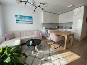 a living room with a couch and a table at Bratislava, LUCAO Family Apartment, Balcony, Free Parking, Aircondition, 8km Old Town in Bratislava