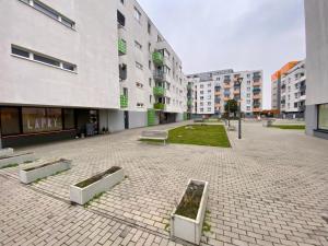 a courtyard of a building with benches and buildings at Bratislava, LUCAO Family Apartment, Balcony, Free Parking, Aircondition, 8km Old Town in Bratislava +4 photos