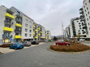 a street with cars parked in front of buildings at Bratislava, LUCAO Family Apartment, Balcony, Free Parking, Aircondition, 8km Old Town in Bratislava
