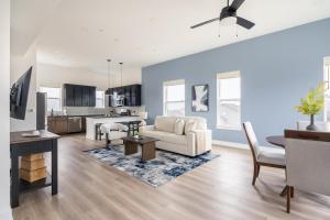 a living room with a couch and a table at Landing Beautiful 2BD in Lees Summit in Lees Summit