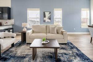 a living room with a couch and a coffee table at Landing Beautiful 2BD in Lees Summit in Lees Summit