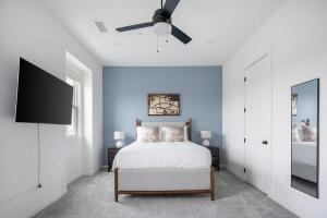 a bedroom with a bed and a ceiling fan at Landing Beautiful 2BD in Lees Summit in Lees Summit