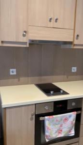 a kitchen with an oven with a towel on it at Golem Central Stay in Golem