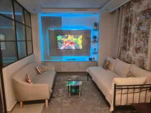 a living room with two couches and a tv at Casa Via Egnatia in Komotini