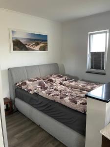 a bedroom with a bed in a room with a window at Ferienhaus Usedom in Kamminke +8 photos