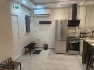 a kitchen with a stainless steel refrigerator and a stove at Casa Via Egnatia in Komotini +5 photos