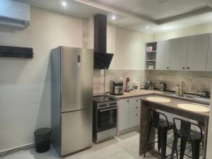 a kitchen with a stainless steel refrigerator and a counter at Casa Via Egnatia in Komotini