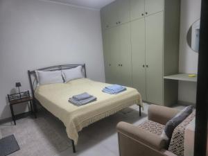 a small bedroom with a bed and a chair at Casa Via Egnatia in Komotini
