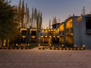 a large building with lights in front of it at The Pioneer Hotel in Skardu