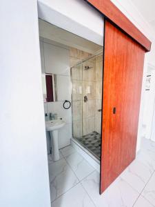 a bathroom with a shower and a sink at Brytelight Luxe 1 Bedroom in Rustenburg
