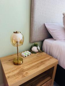 a table with a lamp on it next to a bed at Brytelight Luxe 1 Bedroom in Rustenburg