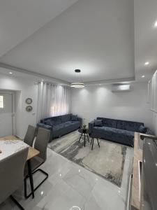 a living room with two blue couches and a table at Peaceful House in Përmet