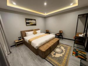 a bedroom with a large bed in a room at The Pioneer Hotel in Skardu