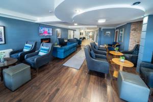 a waiting room with blue couches and tables at Inn On The Coast in Portrush