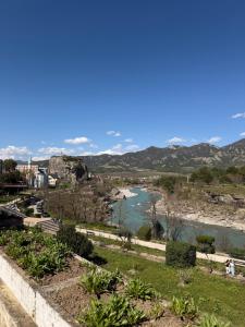 a view of a river with mountains in the background at Peaceful House in Përmet
