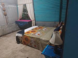 a bedroom with a bed and a table with a lamp at Casa de playa MC in Quepos +14 photos