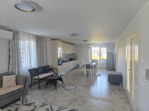 a living room with a couch and a table at Ariona apartment in Draç