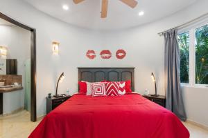 a bedroom with a large red bed with red pillows at Luxe 3 King BR Villa | Infinity Pool + 220° Views in Puerto Vallarta