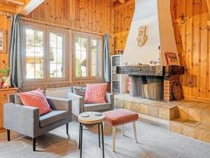 a living room with chairs and a fireplace at Chalet-Apartment mit Balkon & Gratis Parkplatz in Lenk +29 photos