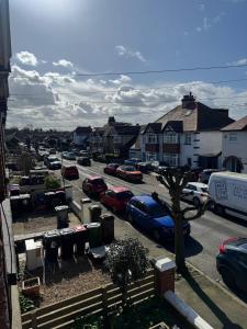 a parking lot with cars parked in a town at 2 bed apartment close to beach in Herne Bay