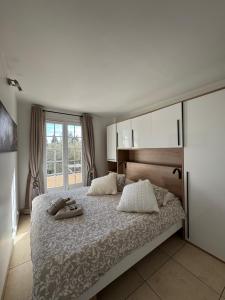 a bedroom with a bed with two slippers on it at L'Arche de Porquerolles in Porquerolles