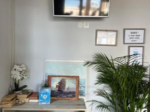 a room with a table with a painting on the wall at Hotel Prinos in Himare +46 photos