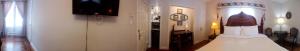 a living room with a bed and a television at Waterfront Hideaway Private Suite-King bed room in Tottenham
