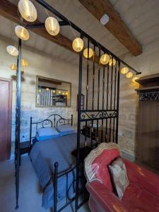 a bedroom with a black bed and a couch at Paddy's Studio in Il-Ħamra