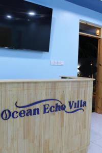 a sign for an ocean echo villa on a desk at Ocean Echo Villa in Mathiveri