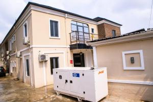 a large white appliance in front of a house at VHS Vinchee Suites II in Lagos