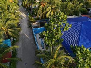 an overhead view of a building with palm trees at Ocean Echo Villa in Mathiveri