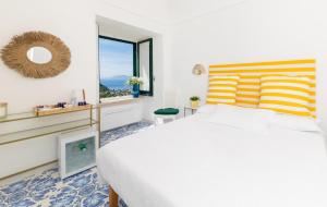 a bedroom with a large bed and a window at La Gloriette in Capri